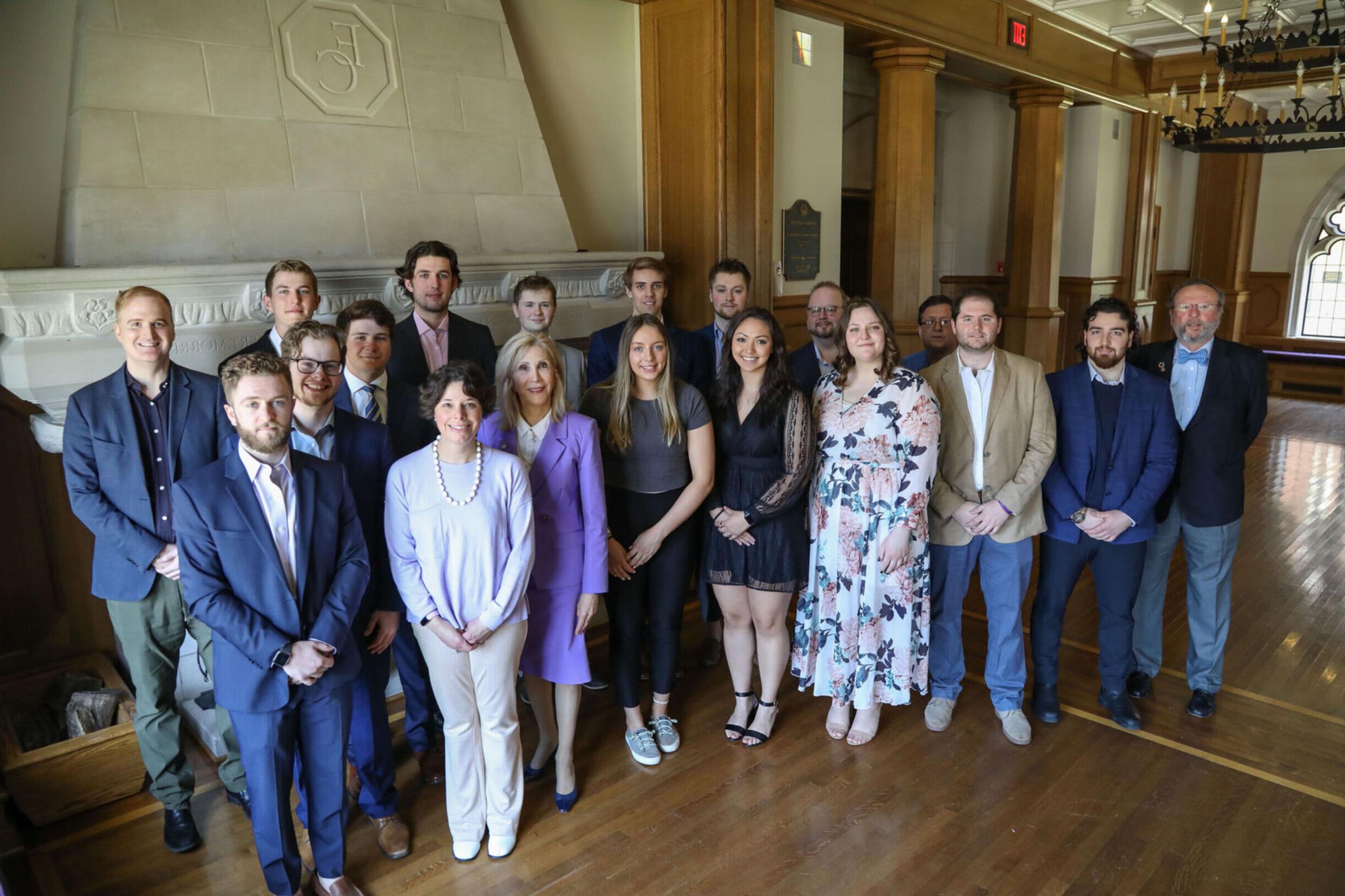 Students inducted into the Sigma Beta Delta Honor Society for Business stand with faculty during the 2023 induction ceremony